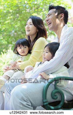 Family of Four Sitting on Bench View Large Photo Image Stock Image - Family of Four Sitting on Bench. Fotosearch