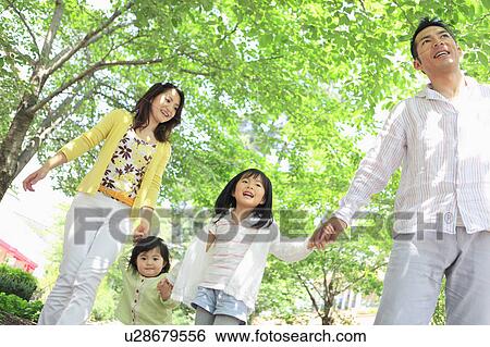 Family of Four Walking in Park View Large Photo Image Stock Photograph - Family of Four Walking in Park. Fotosearch