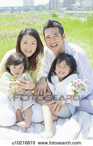 Family of Four with Bunch of Wildflowers View Large Photo Image Stock Photo - Family of Four with Bunch of Wildflowers. Fotosearch