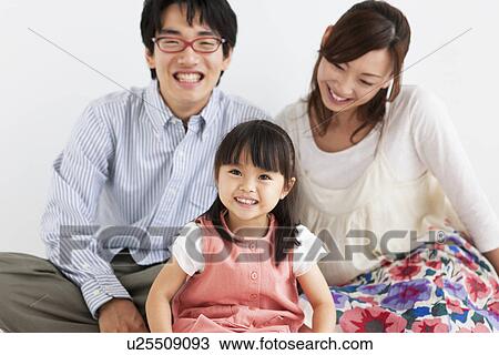 Family sitting and smiling View Large Photo Image Stock Image - Family sitting and smiling. Fotosearch
