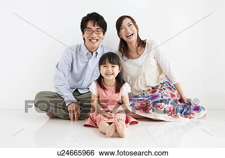 Stock Photograph - Family sitting and smiling. Fotosearch