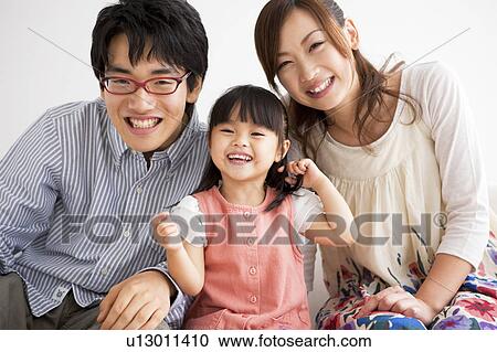 Family sitting on sofa View Large Photo Image Stock Image - Family sitting on sofa . Fotosearch