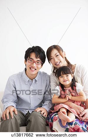 Family sitting on sofa View Large Photo Image Stock Image - Family sitting on sofa . Fotosearch