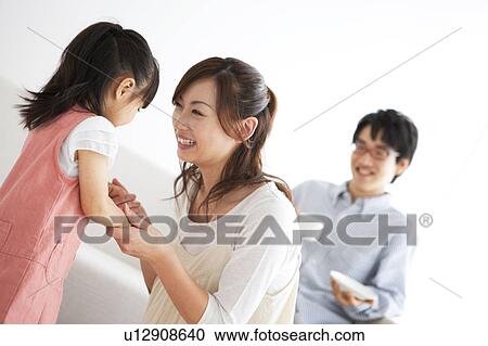 Stock Image - Family smiling. Fotosearch