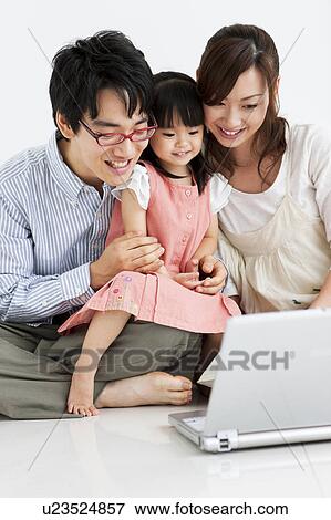 Family using laptop View Large Photo Image Stock Photo - Family using laptop. Fotosearch