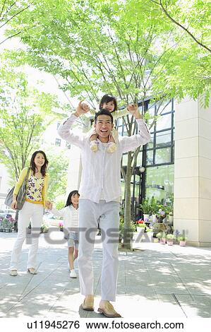 Father Carrying Daughter on Shouldrs, Mother and Another Daughter Following Behind View Large Photo Image Stock Photograph - Father Carrying Daughter on Shouldrs, Mother and Another Daughter Following Behind. Fotosearch