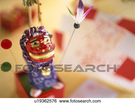 Stock Photograph - Figurine of lion shishimai. Fotosearch