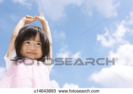 Stock Image - Girl Against Blue Sky. Fotosearch