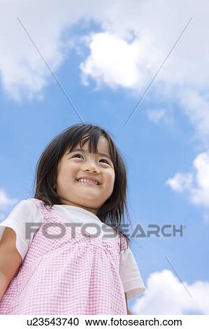 Stock Image - Girl Against Blue Sky. Fotosearch