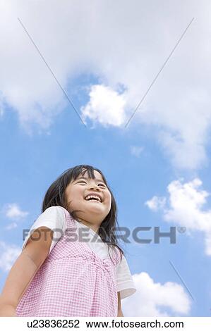 Stock Image - Girl Against Blue Sky. Fotosearch