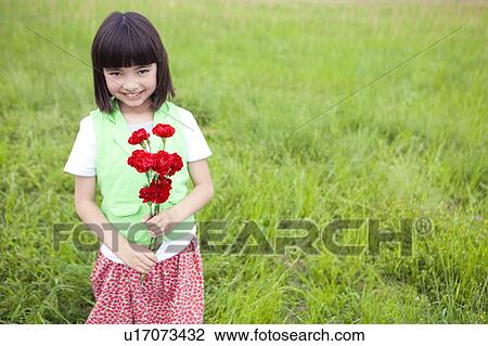 Stock Image - Girl Holding Bunch of Flowers. Fotosearch