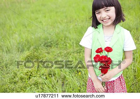 Stock Image - Girl Holding Bunch of Flowers. Fotosearch