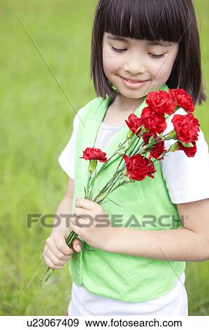 Stock Photo - Girl Holding Bunch of Flowers. Fotosearch