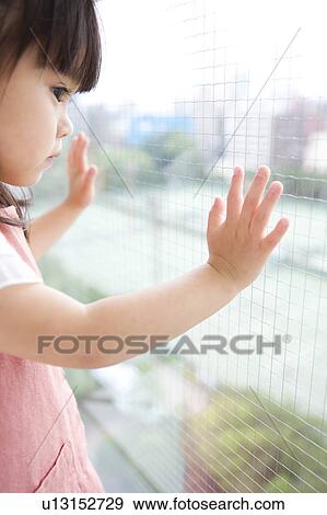 Girl looking out the window View Large Photo Image Stock Photo - Girl looking out the window. Fotosearch
