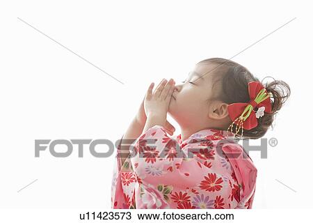 Stock Image - Girl Praying During Shichi-Go-San Festival. Fotosearch