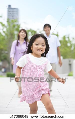Girl Running, Parents in Background View Large Photo Image Stock Photo - Girl Running, Parents in Background. Fotosearch