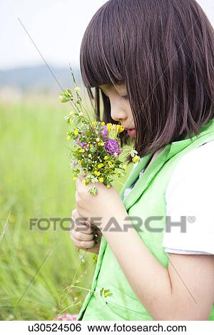 Girl Smelling Wildflowers View Large Photo Image Stock Photograph - Girl Smelling Wildflowers. Fotosearch