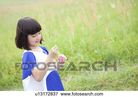 Stock Photo - Girl with Bubble Wand. Fotosearch