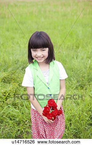 Stock Photograph - Girl with Bunch of Red Flowers. Fotosearch