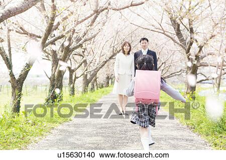Girl with Randoseru running to parents, rear view View Large Photo Image Stock Image - Girl with Randoseru running to parents, rear view. Fotosearch