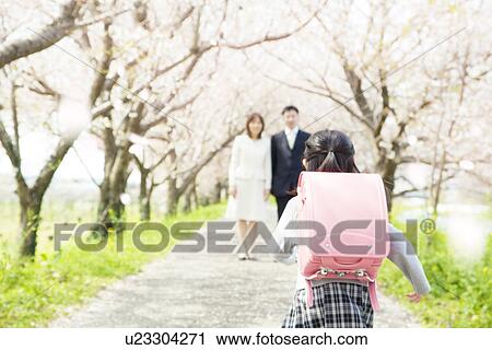 Girl with Randoseru running to parents, rear view View Large Photo Image Stock Image - Girl with Randoseru running to parents, rear view. Fotosearch