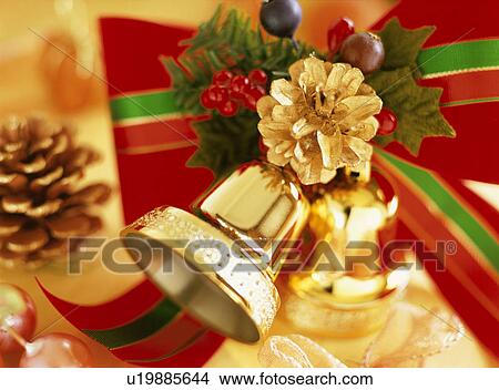 Gold pine cone, holly and bell View Large Photo Image Picture - Gold pine cone, holly and bell. Fotosearch