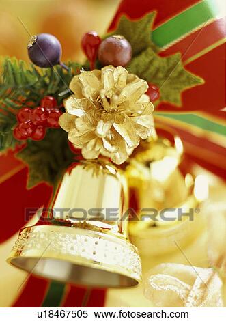 Stock Photography - Gold pine cone, holly and bell. Fotosearch