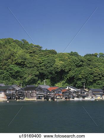 Stock Image - Hosues and Boats at Coast. Fotosearch