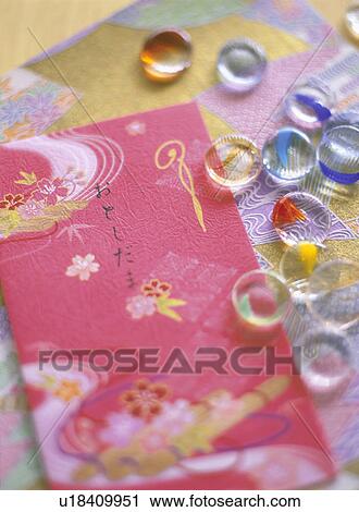 Stock Image - Japanese money envelope and Japanese marbles. Fotosearch