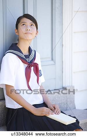 Junior High School girl holding a book View Large Photo Image Picture - Junior High School girl holding a book. Fotosearch