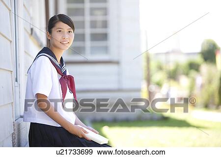 Stock Photo - Junior High School girl holding a book. Fotosearch