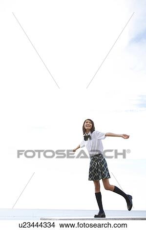 Junior High School girl with arms raised View Large Photo Image Picture - Junior High School girl with arms raised. Fotosearch