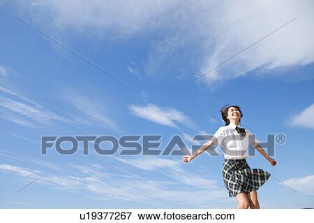 Stock Photo - Junior High School girl with arms raised. Fotosearch