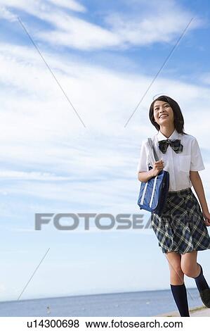 Stock Photo - Junior High School girl with shoulder bag. Fotosearch