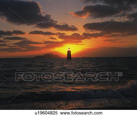 Stock Photography - Lighthouse in Sea at Dawn. Fotosearch