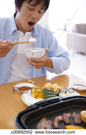 Stock Image - Man Eating Dinner. Fotosearch