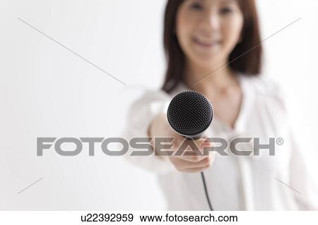 Mid Adult Holding Up Microphone View Large Photo Image Stock Photo - Mid Adult Holding Up Microphone. Fotosearch