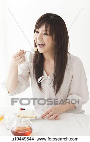 Mid Adult Woman Eating Cake View Large Photo Image Picture - Mid Adult Woman Eating Cake. Fotosearch