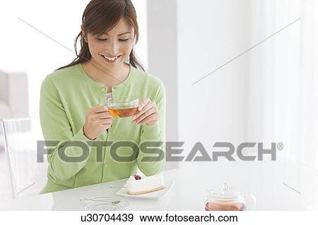 Mid Adult Woman Having Tea and Cake View Large Photo Image Stock Photo - Mid Adult Woman Having Tea and Cake. Fotosearch