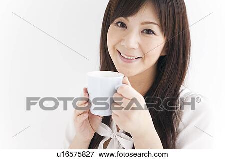 Stock Photo - Mid Adult Woman Having Tea. Fotosearch