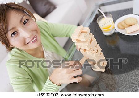 Mid Adult Woman Playing Jenga View Large Photo Image Stock Image - Mid Adult Woman Playing Jenga. Fotosearch