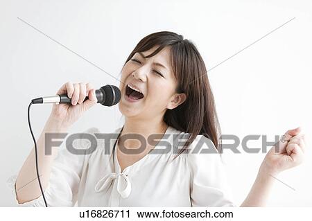 Stock Image - Mid Adult Woman Singing. Fotosearch