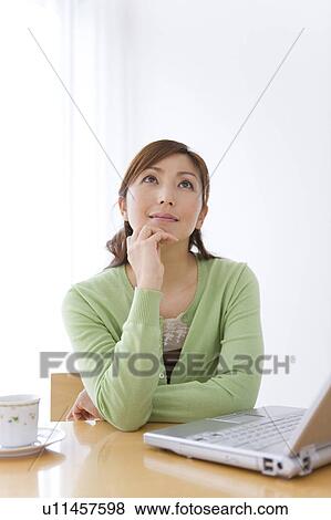 Mid Adult Woman Using Laptop and Thinking View Large Photo Image Stock Photo - Mid Adult Woman Using Laptop and Thinking. Fotosearch