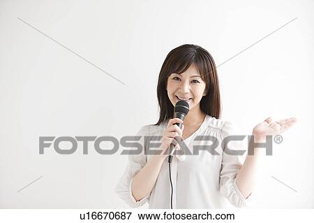 Stock Photo - Mid Adult Woman with Microphone. Fotosearch