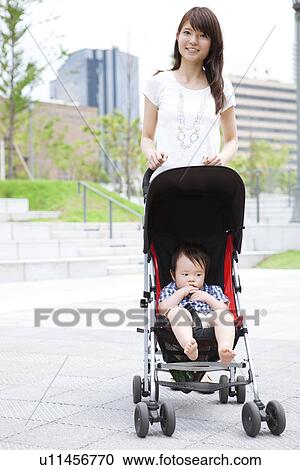 Stock Image - Mother and Baby Boy in Buggy. Fotosearch