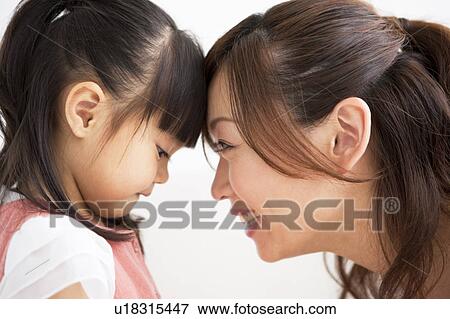 Mother and daughter touching forehead View Large Photo Image Stock Photo - Mother and daughter touching forehead. Fotosearch