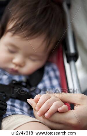 Stock Photo - Mother Holding Baby Boy's Hand. Fotosearch