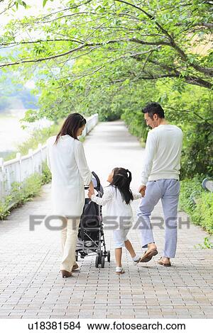 Parents and Daughter Walking in Park View Large Photo Image Picture - Parents and Daughter Walking in Park. Fotosearch