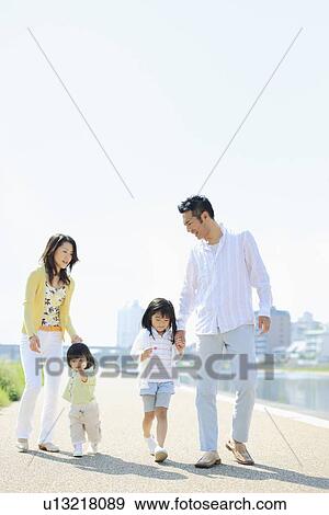 Parents and Two Daughters Walking at Waterfront View Large Photo Image Stock Photo - Parents and Two Daughters Walking at Waterfront. Fotosearch