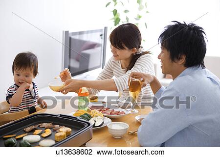 Parents Feeding Baby Boy at Dinner Table View Large Photo Image Stock Image - Parents Feeding Baby Boy at Dinner Table. Fotosearch